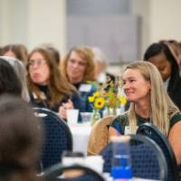 Audience members listening to speaker 4